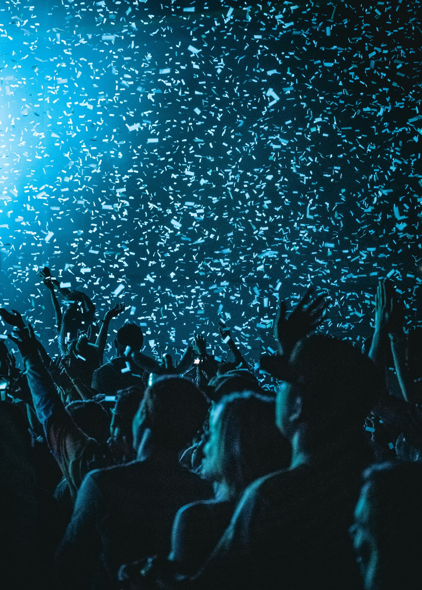 Crowd under falling confetti at a live show